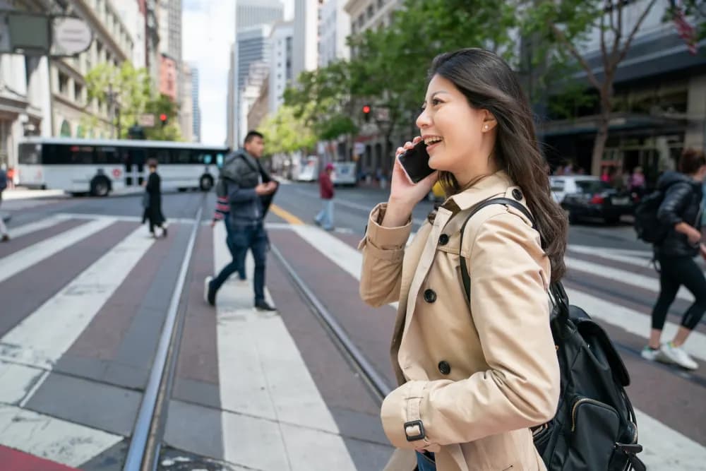 Traveller with a backpack on the phone in the city