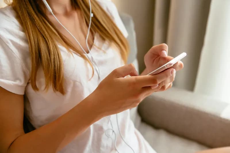 Hands typing on a phone